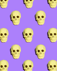 Colorful Halloween concept. Skull pattern on bold purple background. Creative holiday composition.