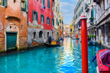 Man paddling Gondola in Venice canal