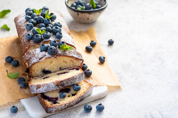 Fototapeta na wymiar fresh blueberry loaf of bread muffin cake with mint closeup on a table