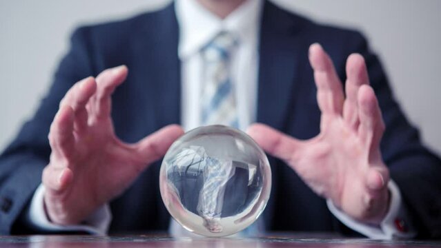 Cinemagraph of a business man looking at a crystal ball
