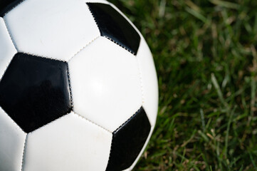 Fototapeta na wymiar Soccer ball on grass lawn close up