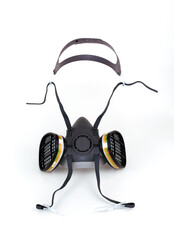 Reusable half-face elastomeric respirator for air purification with replaceable filters on a white background
