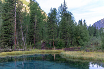 Amazing blue geyser lake in the mountains of Altai, Russia