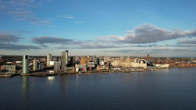 Slow aerial footage of the Liverpool waterfront at sunset