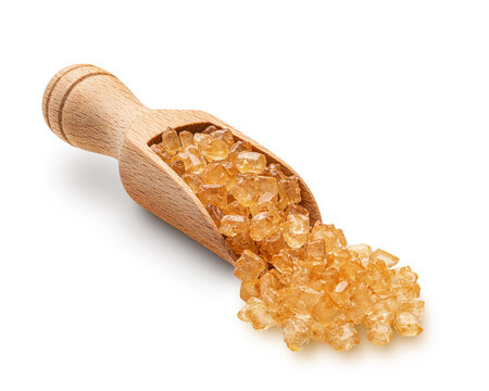 Large brown sugar crystals scuttered from wooden scoop