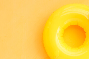 Inflatable ring on yellow background. Summer background concept