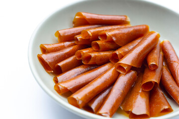 Dried mango paste sheets on white background.