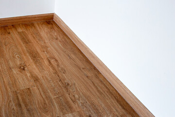 Laminate wood floor with blank white wall