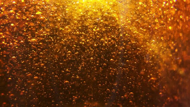 Golden bubbles background. Bubbles floating into golden viscous liquid.
