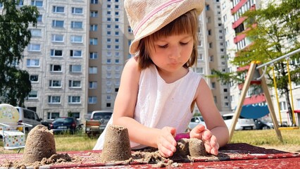 SMALL GIRL playing at playground at backyard of blocks of flats © Maria
