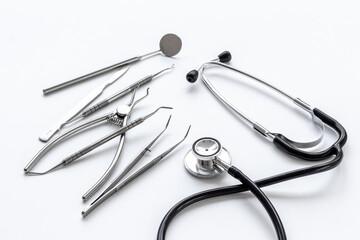 Dental or surgical steel instruments with stethoscope. Healthcare background