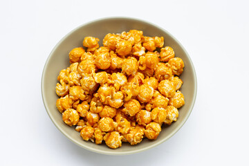 Honey caramel popcorn on white background.
