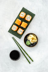 Japanese cuisine. Salmon sushi rolls on eco green papper plate