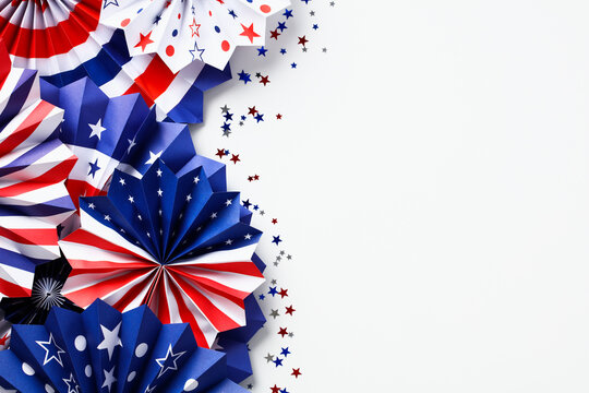 USA paper fans and confetti on white desk table, top view. Happy Labor Day, Independence Day, Presidents Day banner mockup