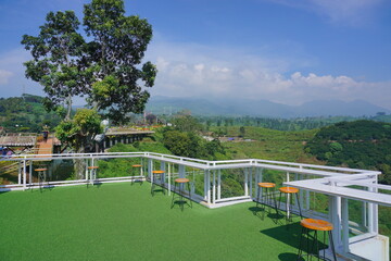 Fototapeta premium Table and chairs in the cafe with nature background. Natural cafe in the tea gardens. 