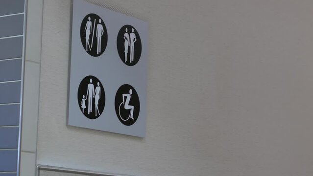 The motion of man and woman washroom logo on the wall inside Burnaby shopping mall with 4k resolution