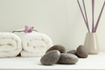 Pile of spa stones on white wooden table