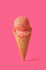 Delicious ice cream in waffle cone on pink background