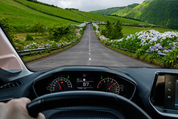 Driver view to the road with beautiful green landscape view from inside a car of driver POV of the...