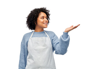 cooking, culinary and people concept - happy smiling woman in apron holding something imaginary on empty hand over white background