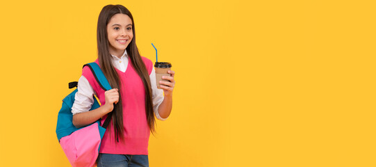 happy teen school girl with backpack drink takeaway cocoa on yellow background, lunch. Banner of school girl student. Schoolgirl pupil portrait with copy space.