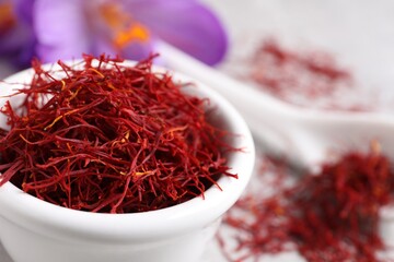 Dried saffron and crocus flowers on table, closeup. Space for text