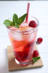 Delicious raspberry lemonade made with soda water on white wooden table