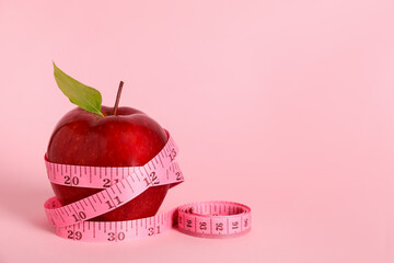 Fresh red apple with measuring tape on pink background. Space for text - obrazy, fototapety, plakaty