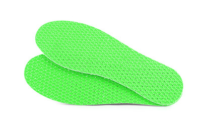 Pair of green orthopedic insoles on white background