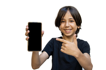 Naklejka premium Smiling young asian boy holds a smartphone in his hand and shows his finger on a blank screen. Happy brunette boy pointing at phone with blank screen in his hand. Isolated on a white background