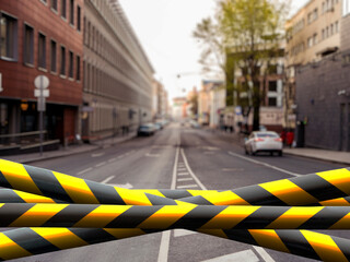 black and yellow safety tape outdoors in the street, restricted area