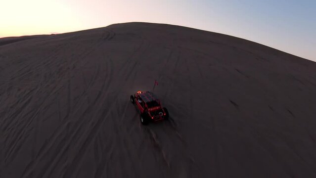 Offroad Dune Buggy driving in the desert Sand Dunes at dusk