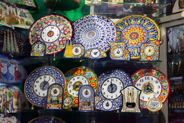 Variety of traditional colorful handcrafted ceramics on shelves of souvenir shop in Barcelona