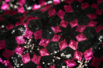 Black and pink shiny sequin stars texture bg detail