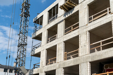 Building under construction. Construction site against blue sky. Industrial background