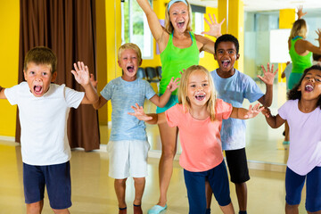 Positive children in dance studio smiling and having fun. High quality photo