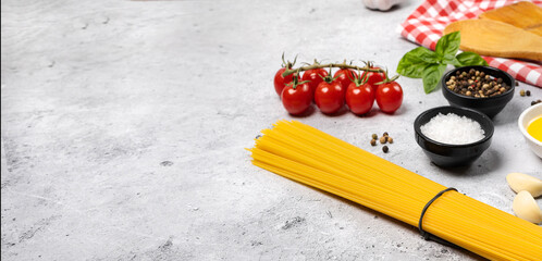 Food background from pasta, spices, herb on black table