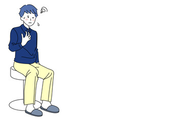 椅子に座る私服の若い男性