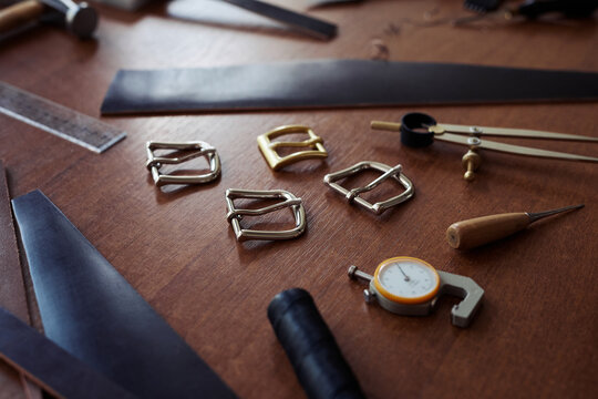 Close up background image of hardware and tools on table in leatherworking shop, copy space