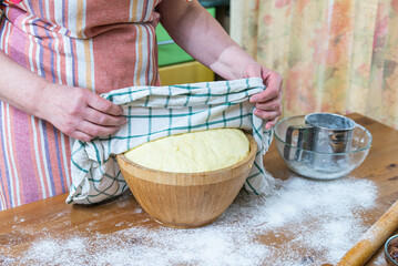 The hostess opens the risen dough. Dough that has doubled in size, dough that has risen, proofed...