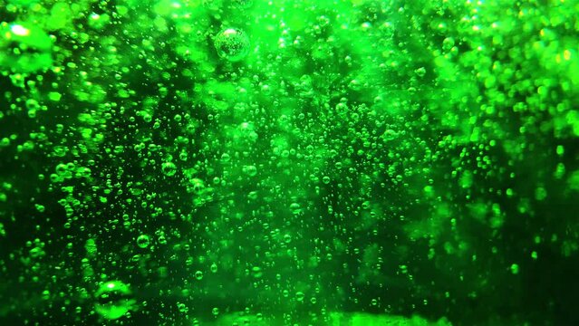Green bubbles background. Bubbles floating into greeninsh viscous liquid.

