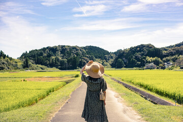A summer girl wearing a straw hat in the countryside..