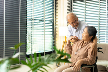 Senior Elderly Couple hold hands together after retirement, Husband wife person take care each other in romantic time with smile happy enjoy. Asian grandparent sit on wheel chair looking, copy space