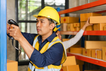 Asian man and woman Inventory Manager checking Stock of Parcels with Products Ready for Shipment.