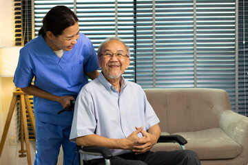 Asian Nurse take care Elderly Senior Man with warm welcome. 70s Mature Man patient has good health and support help by Caregiver from medical hospital. Grandfather sit on wheelchair, copy space