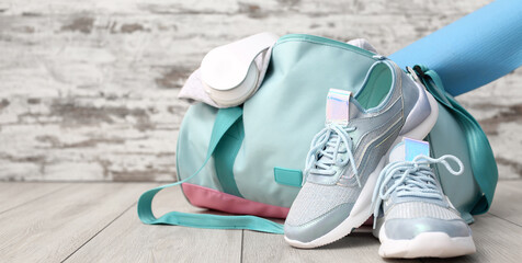 Sports bag and shoes on floor