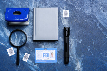 Notebook with document of FBI agent and accessories on color background