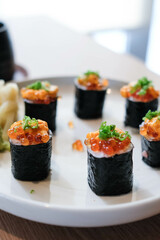 Salmon eggs or Ikura in Japanese style sushi fresh from raw salmond fish in the restaurant.