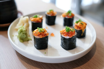 Salmon eggs or Ikura in Japanese style sushi fresh from raw salmond fish in the restaurant.
