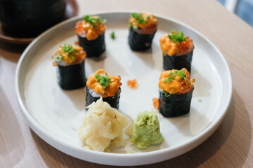 Salmon eggs or Ikura in Japanese style sushi fresh from raw salmond fish in the restaurant.